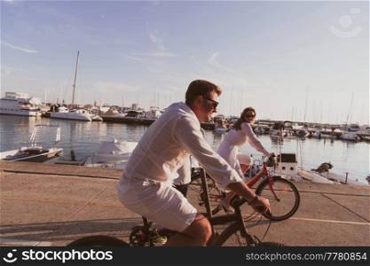 Senior couple enjoying a beautiful morning together riding a bike by the sea. Selective focus. High-quality photo. Senior couple enjoying a beautiful morning together riding a bike by the sea. Selective focus