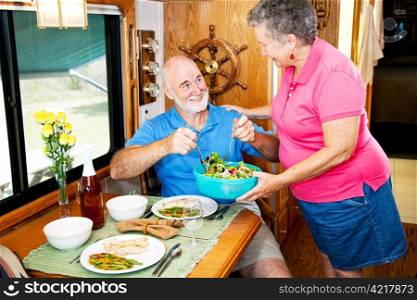 Senior couple enjoying a healthy meal in their luxury motor home.