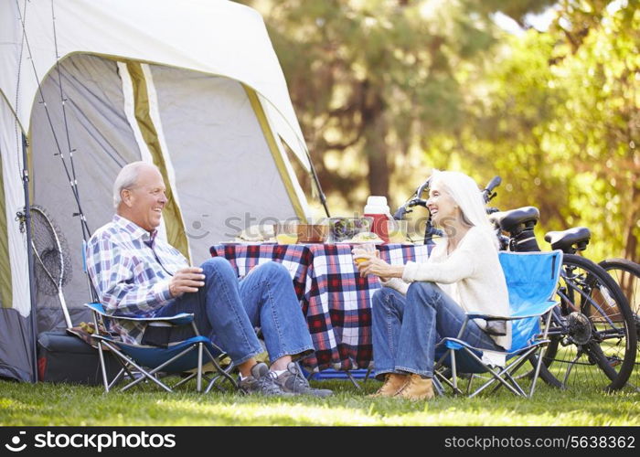 Senior Couple Enjoying Camping Holiday In Countryside