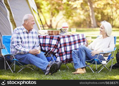 Senior Couple Enjoying Camping Holiday In Countryside