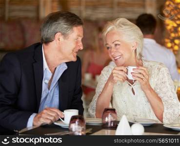 Senior Couple Enjoying Cup Of Coffee In Restaurant