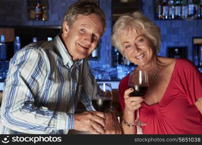 Senior Couple Enjoying Drink In Bar