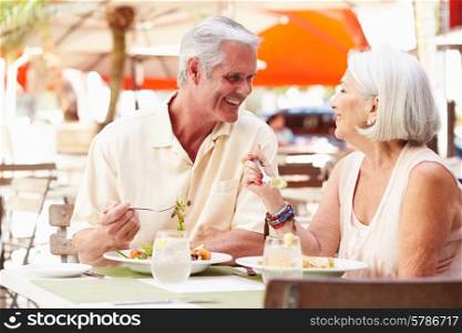 Senior Couple Enjoying Lunch In Outdoor Restaurant