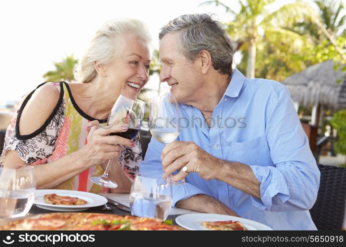 Senior Couple Enjoying Meal In Outdoor Restaurant