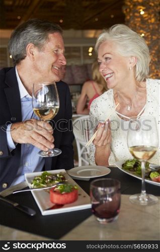 Senior Couple Enjoying Meal In Restaurant