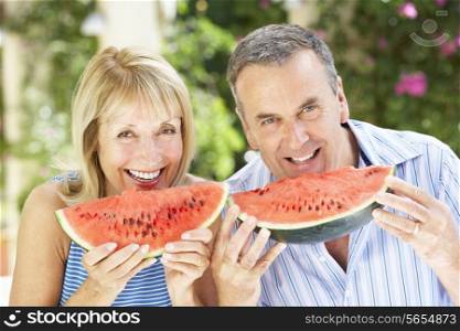 Senior Couple Enjoying Slices Of Water Melon