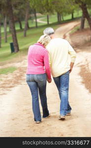 Senior Couple enjoying walk in park