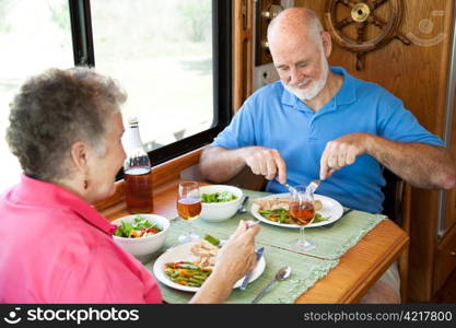 Senior couple enjoys a healthy meal in the kitchen of their RV.