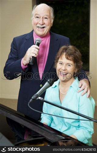 Senior couple enjoys performing vocals and piano together.