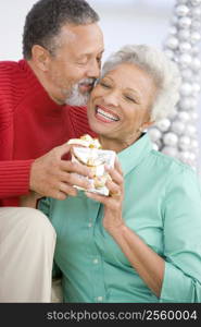 Senior Couple Exchanging A Christmas Gift