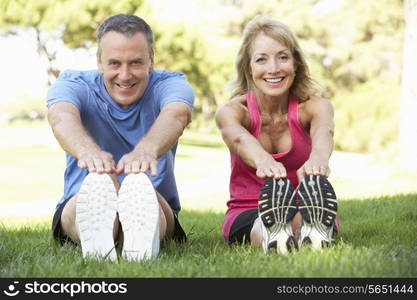 Senior Couple Exercising In Park