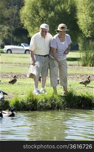 Senior couple feeding ducks