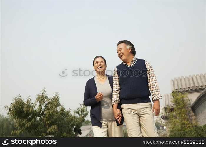 Senior couple going for a stroll in Beijing, holding hands