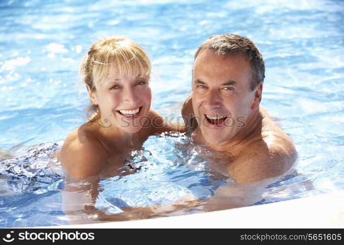 Senior Couple Having Fun In Swimming Pool