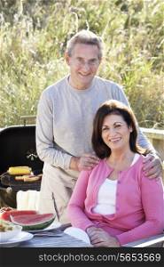 Senior Couple Having Outdoor Barbeque