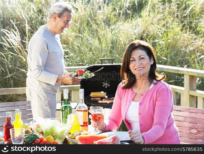 Senior Couple Having Outdoor Barbeque