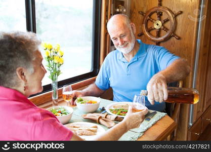 Senior couple having romantic dinner in their motor home.