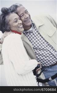 Senior couple holding each other smiling