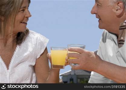 Senior couple holding glasses of juice
