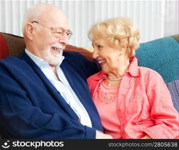 Senior couple in love, flirting on the couch.