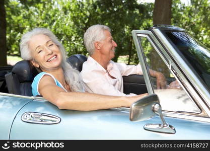 Senior couple in sports car