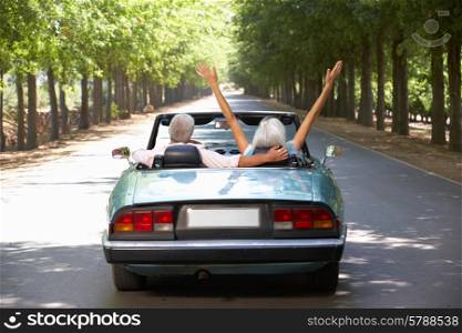 Senior couple in sports car