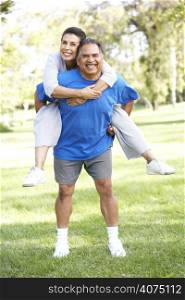 Senior Couple In Sports Clothing Having Fun In Park