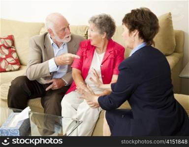 Senior couple in therapy, working out their problems with a counselor.