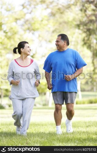 Senior Couple Jogging In Park