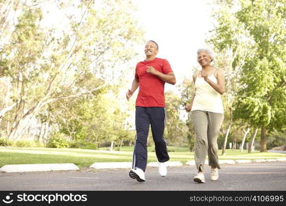 Senior Couple Jogging In Park