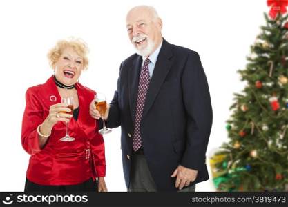 Senior couple laughing and drinking champagne at a Christmas party. Isolated on white.