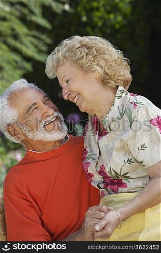 Senior couple laughing outdoors