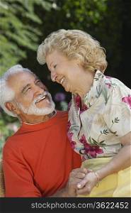 Senior couple laughing outdoors