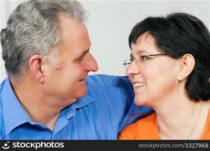 Senior couple looking at each other still in love after all those years