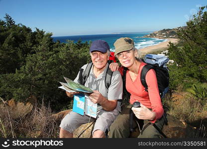 Senior couple looking at map on a rambling day