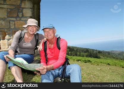Senior couple looking at map on hiking day