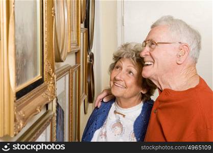 Senior couple looking at photographs