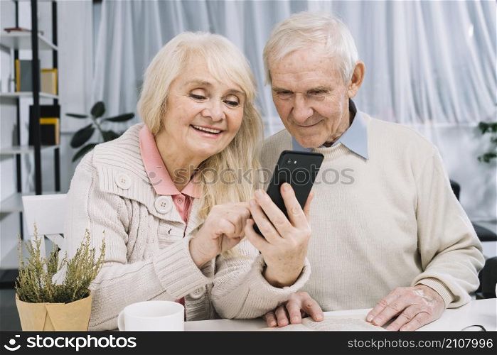 senior couple looking smartphone