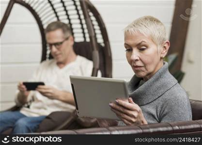 senior couple looking through their devices