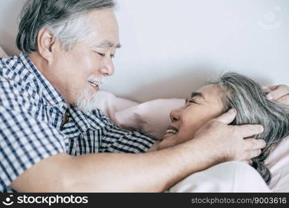 Senior couple lying in bed together