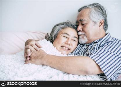 Senior couple lying in bed together