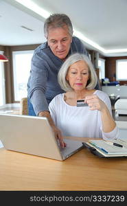 Senior couple making secured payment on internet