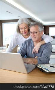 Senior couple making secured payment on internet