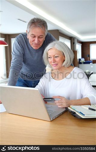 Senior couple making secured payment on internet