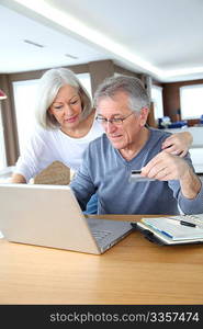 Senior couple making secured payment on internet