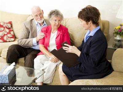 Senior couple meets with a marriage counselor.