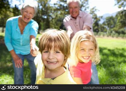 Senior couple on country walk with grandchildren