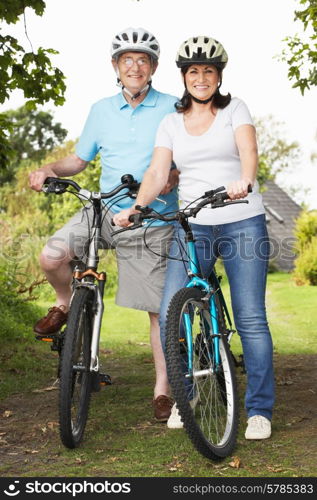 Senior Couple On Cycle Ride In Countryside