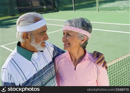Senior couple on tennis court