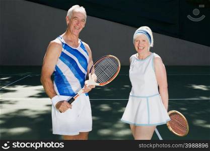 Senior couple on tennis court